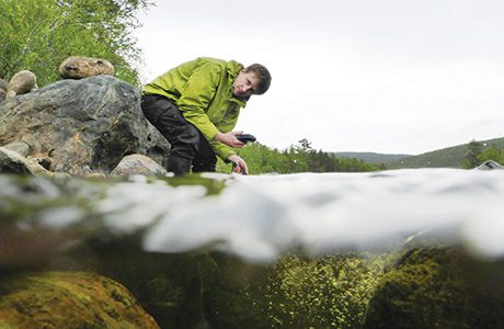 Matt Turley monitoring water quality in the Teno River, Finland