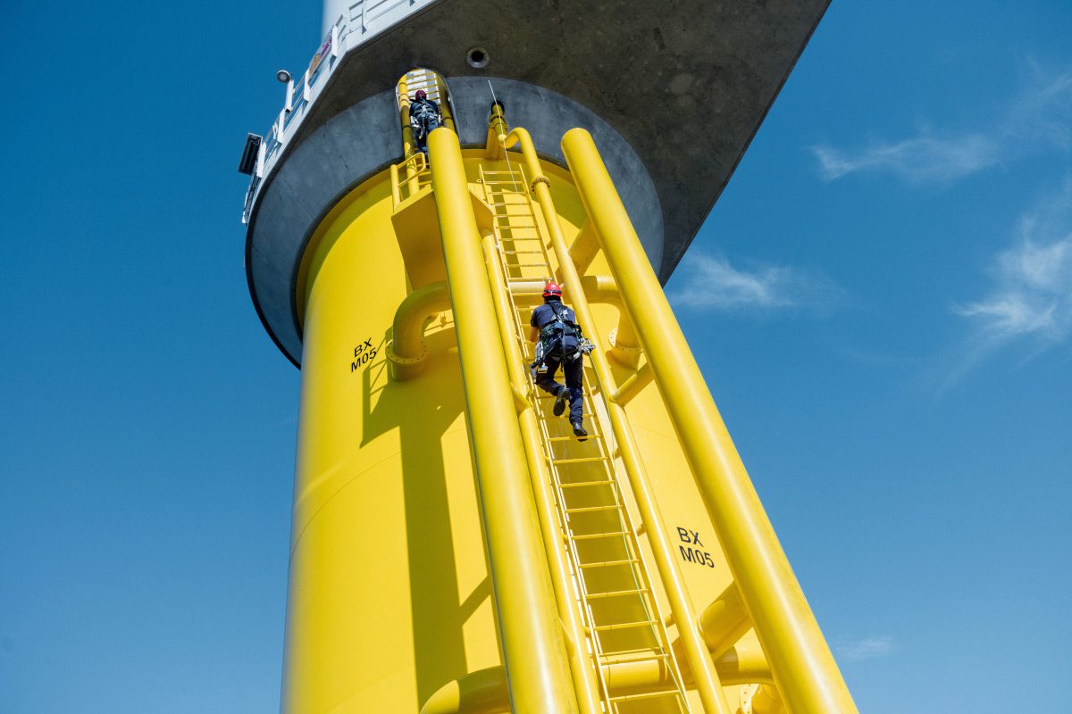 technician-climbing-a-ladder-on-a-wind-turbine