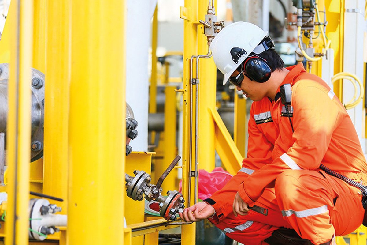 worker checking gas valve