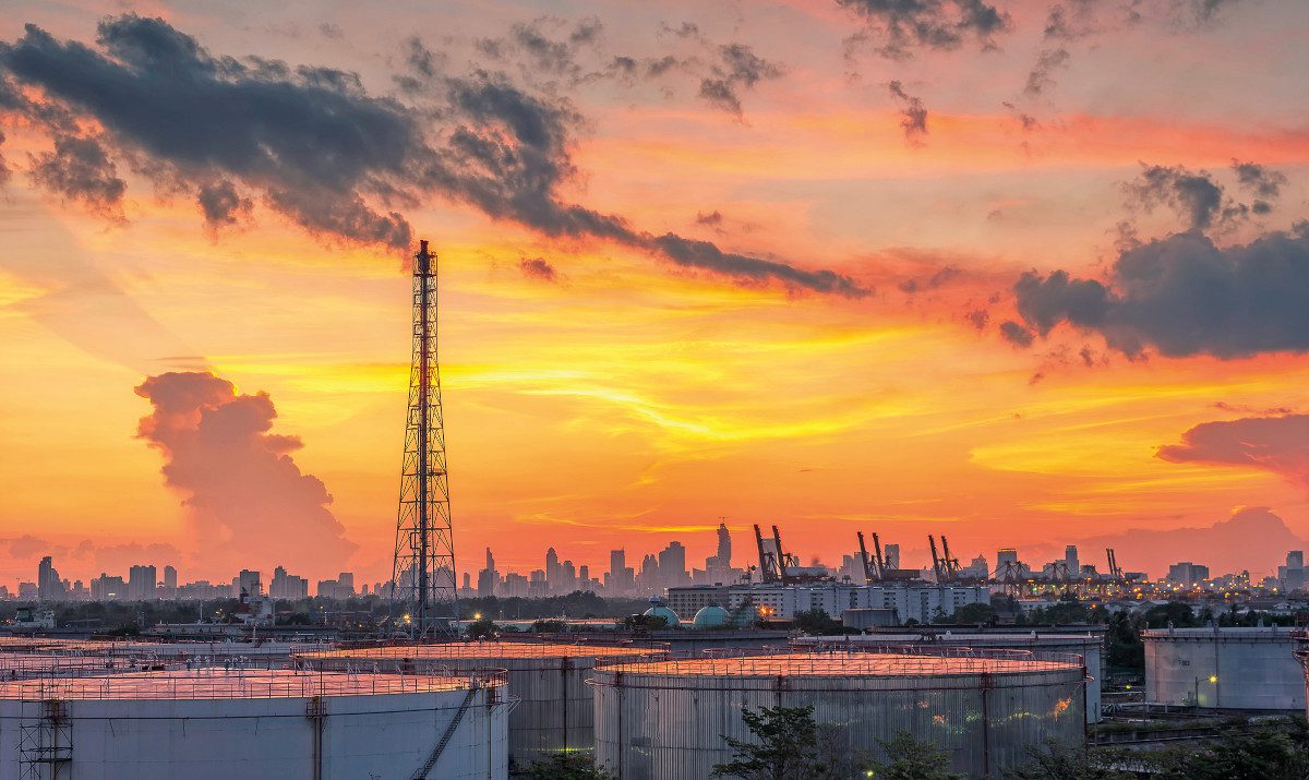 oil and gas refinery at sunset