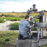Sponsored Content: AUMA commit to continued fast-track actuator delivery Photograph of AUMA employee operating machinery in field