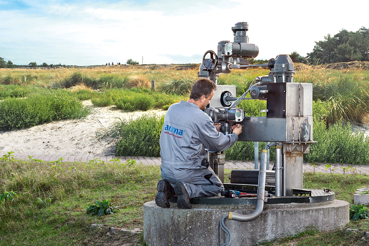 Photograph of AUMA employee operating machinery in field