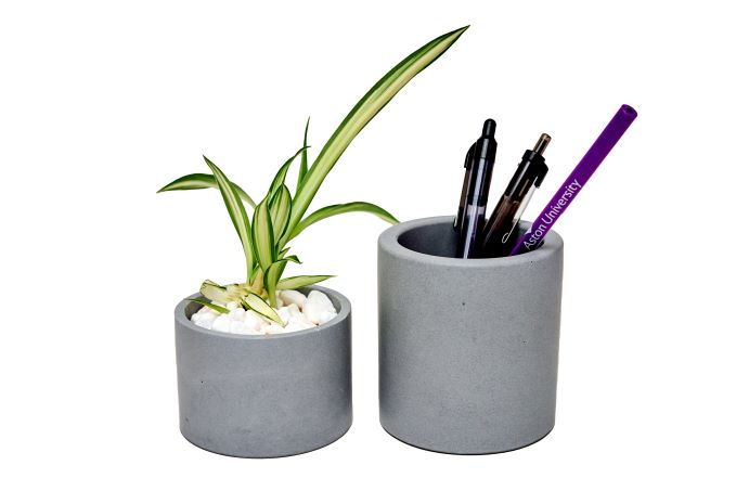 Two dark grey plant pots, one functioning as a plant pot and the other as a pen holder