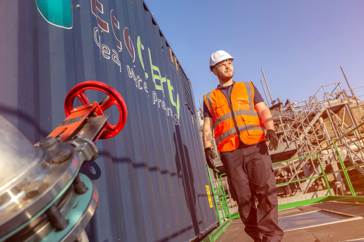 EcoClarity technician standing next to a branded shipping crate