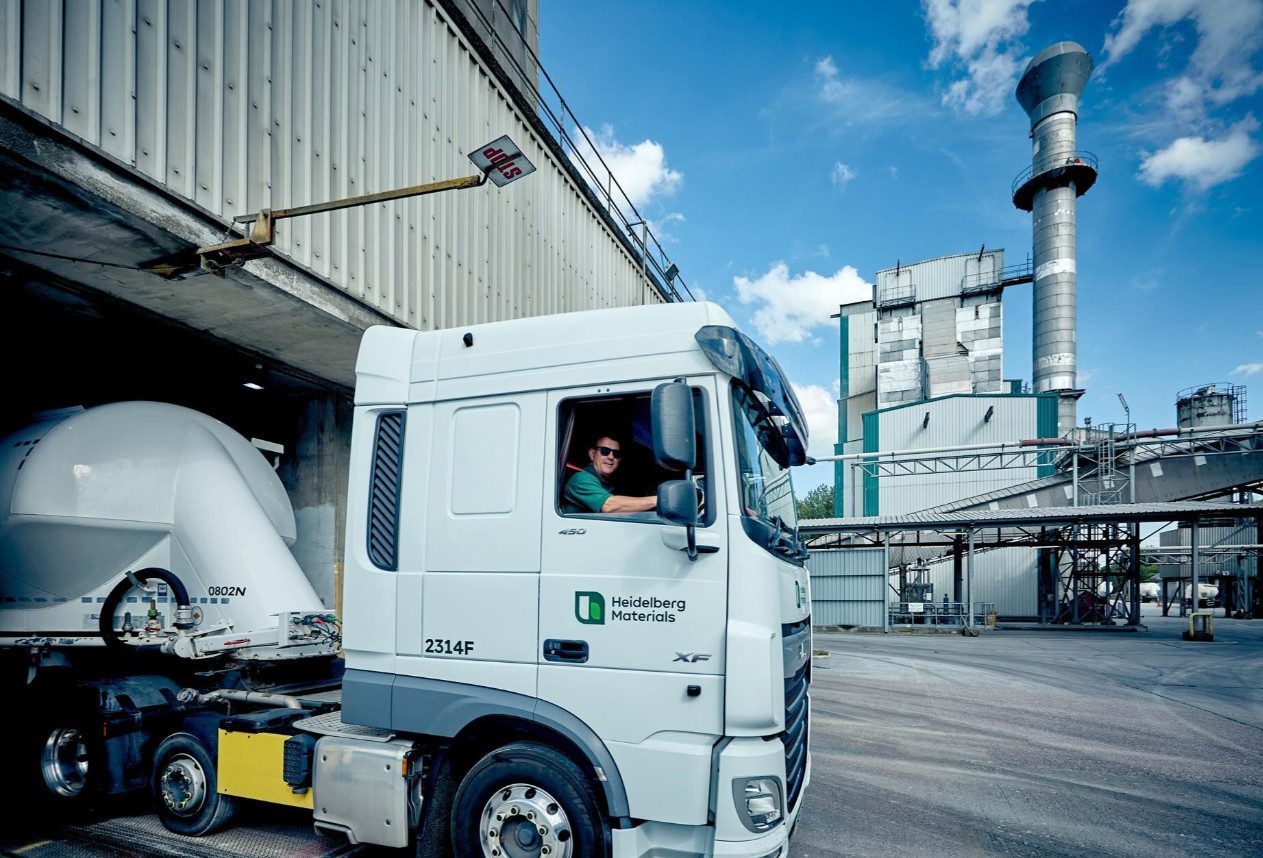 A lorry in the foreground of an outdoor industrial location, seemingly Padeswood Cement