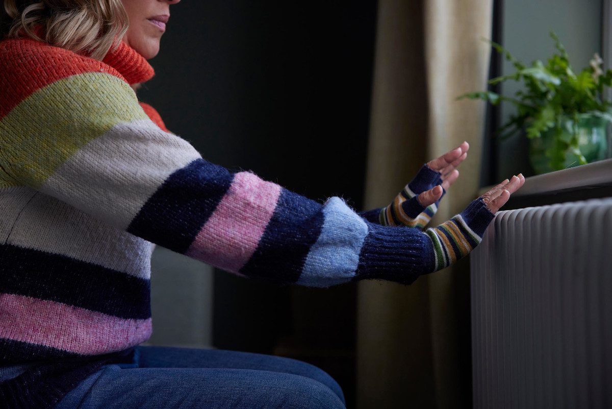 woman crouching at radiator