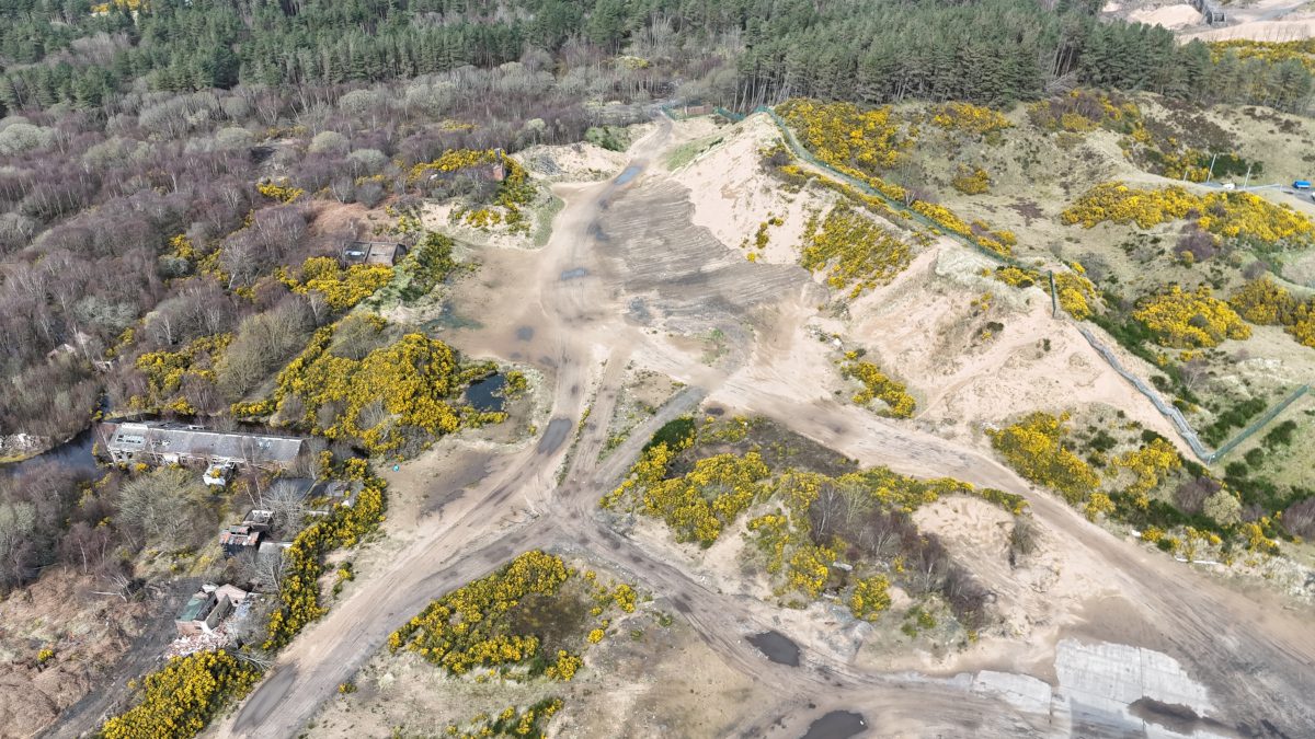 Aerial view of sand dunes and surrounding woodland