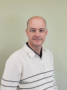 A man smiles at the camera