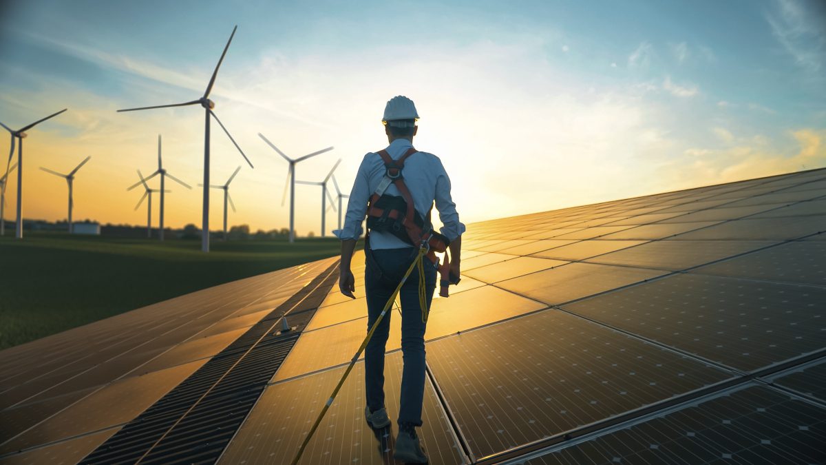 Renewable energy landscape and engineer walking through it