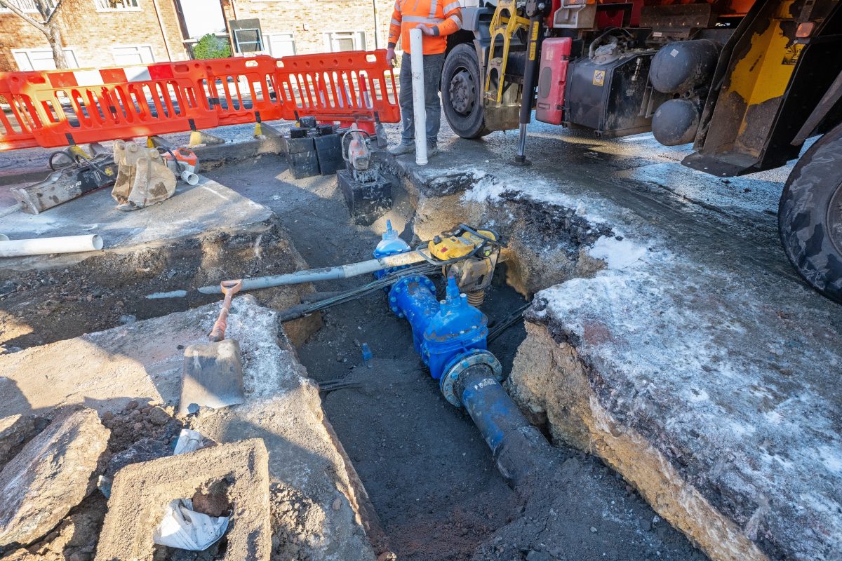 Water main visible within roadworks on a UK urban street