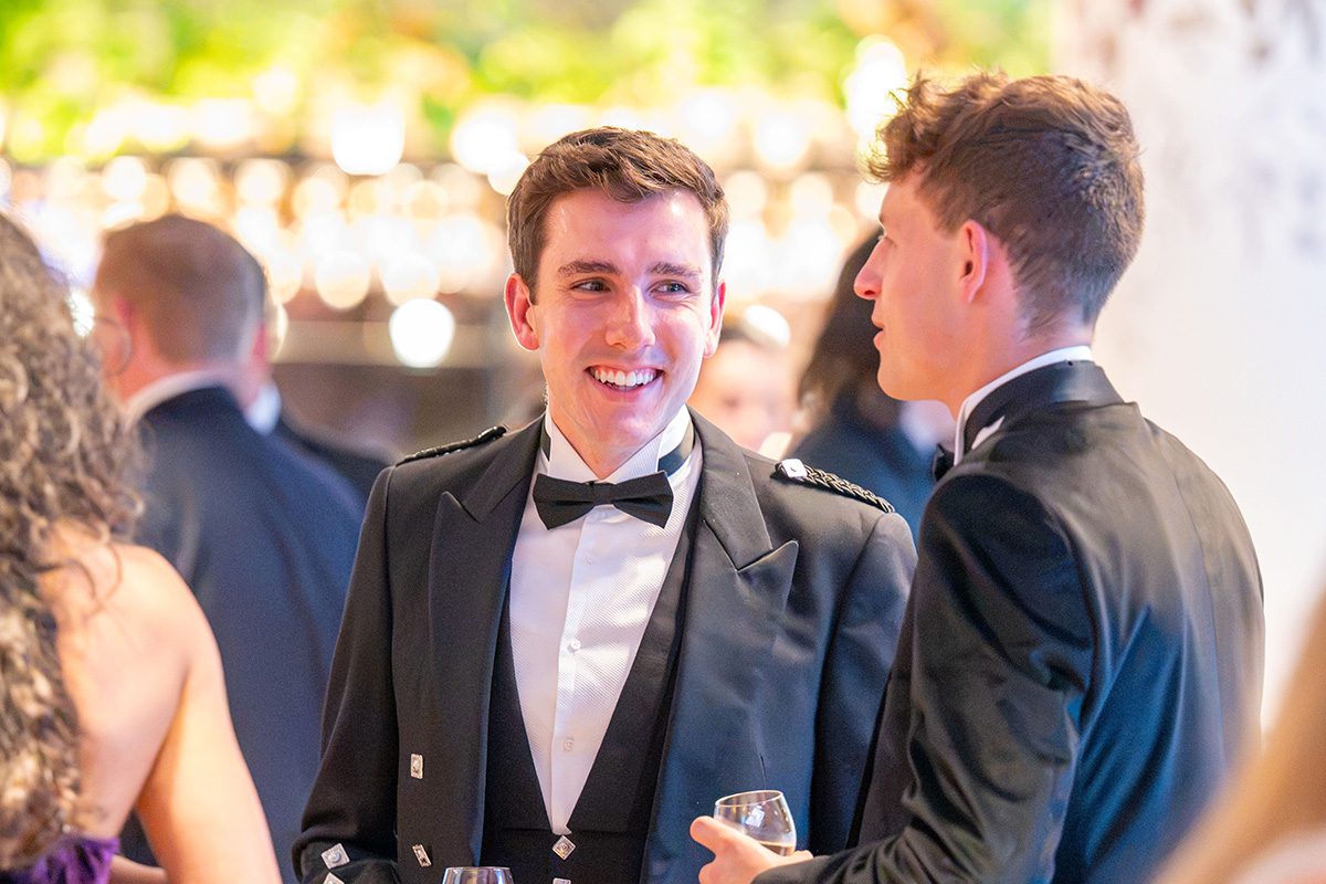 Young people in formal evening attire, socialising at the awards event