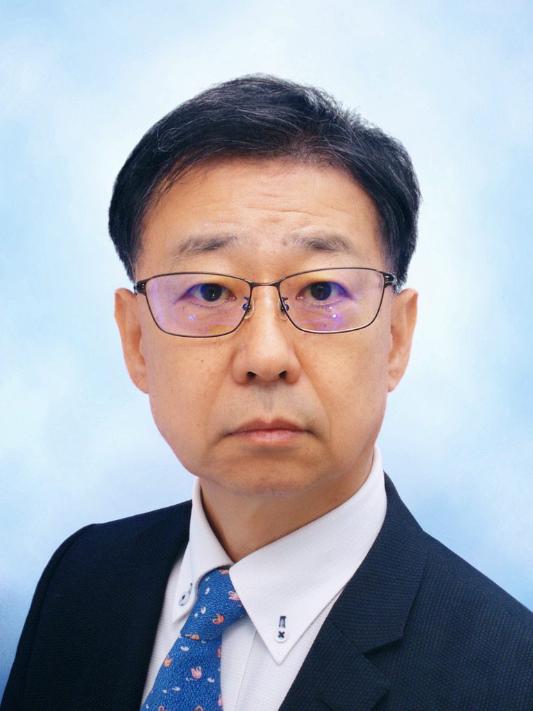 Portrait of Professor Norio Shibata wearing glasses and a dark suit