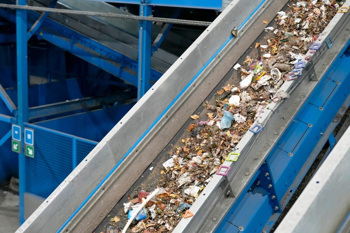 Waste moving along a conveyor for automated sorting and recycling.