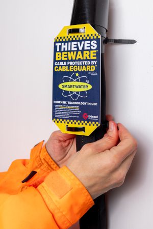 CableGuard protective sleeve fitted around an EV charging cable, with a warning tag stating that the cable is protected by CableGuard and SmartWater