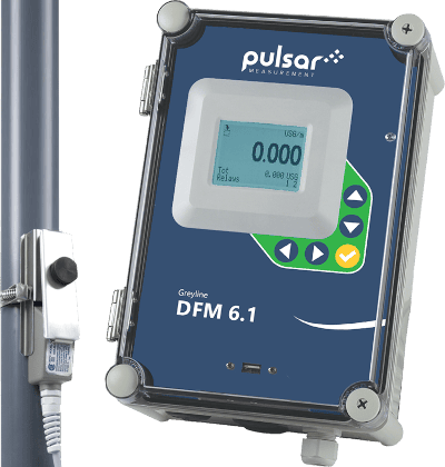 Pulsar Measurement Greyline DFM 6.1 flow meter with digital display and control buttons, mounted alongside a pipe.