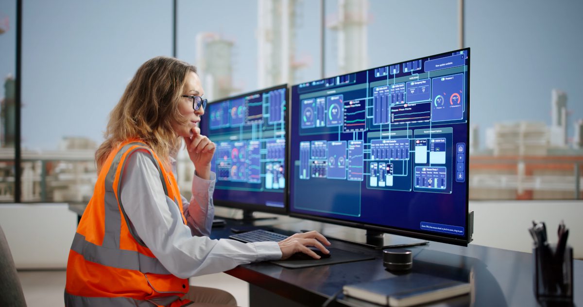 Female Engineer Analyzing Energy Levels In Industrial Control Room Factory